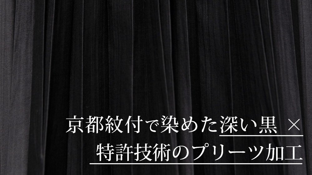 プリーツ×深黒染」 華やぎを添えるリボンが映える、 体型をやさしく